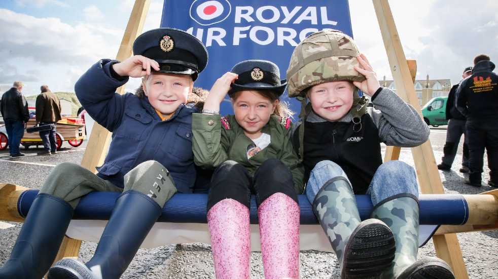 Children sat on Royal Air Force seat